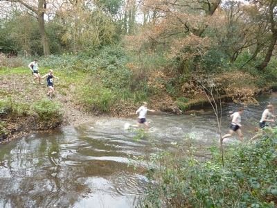 Runners wading through Beverley Brook